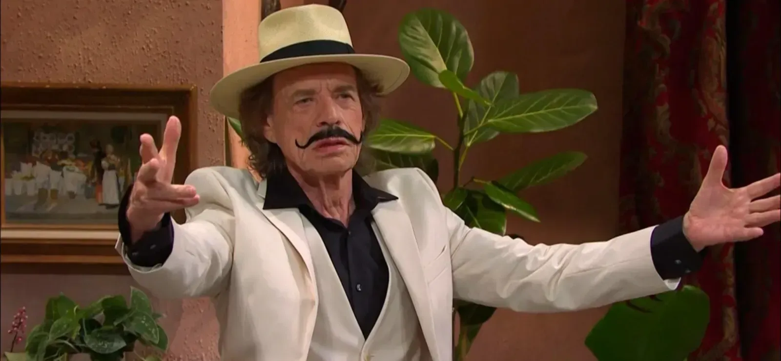 Mick Jagger wearing white suite and fake mustache for SNL episode with Bad Bunny