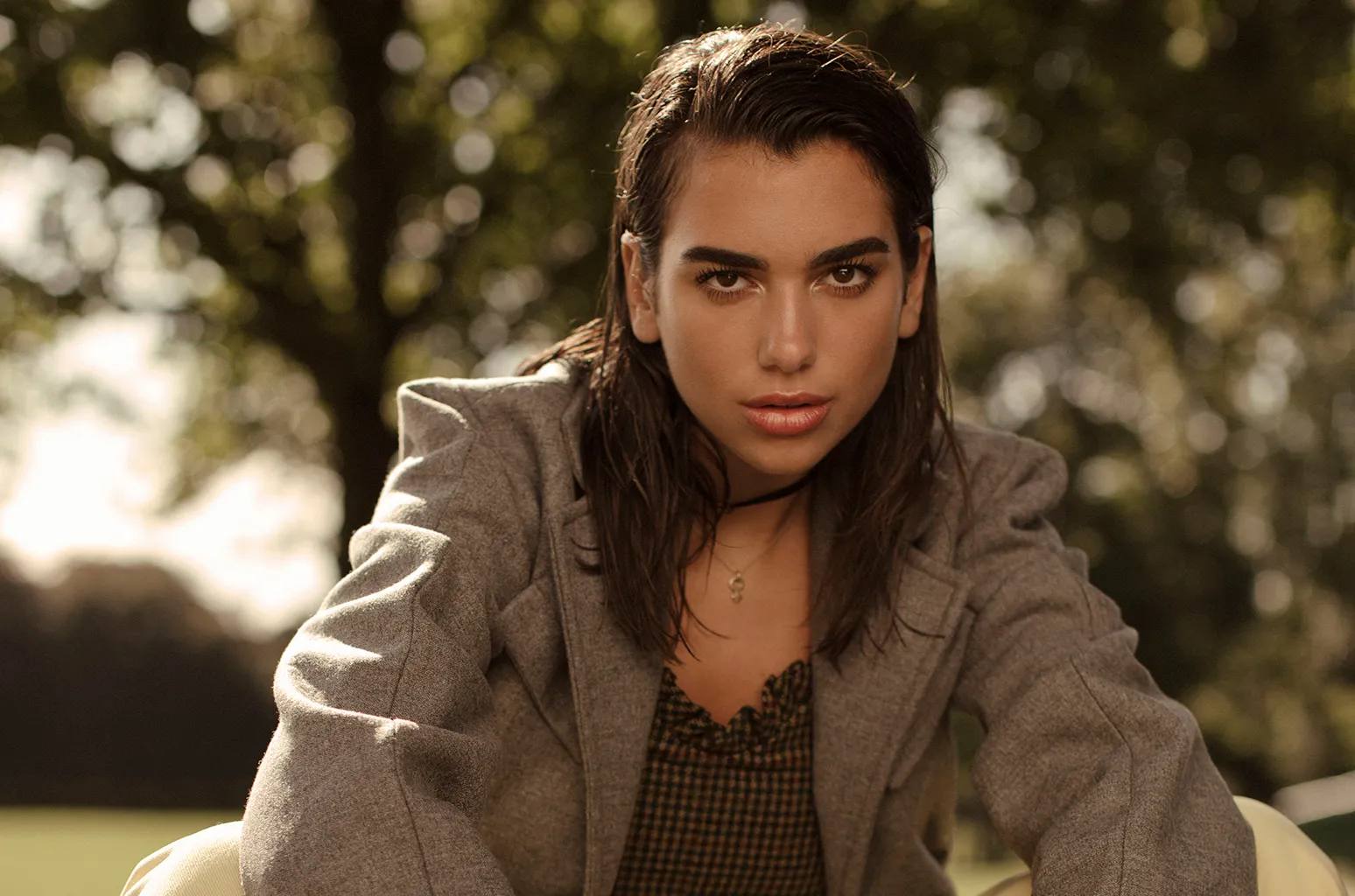 Dua Lipa in a park wearing a costume