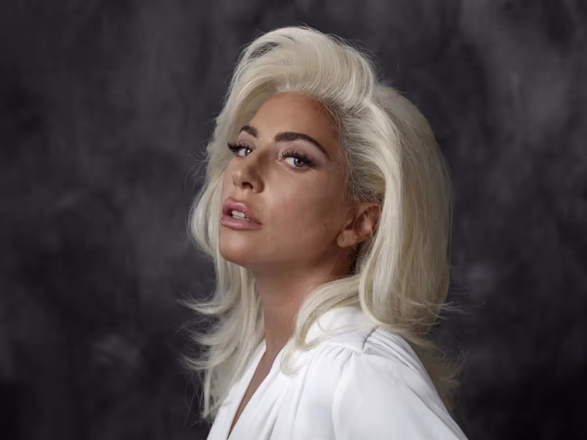 Lady Gaga's Portrait, wearing white suite on dark grey background