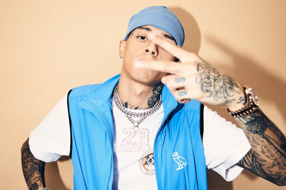 Central Cee wearing blue west and blue hat