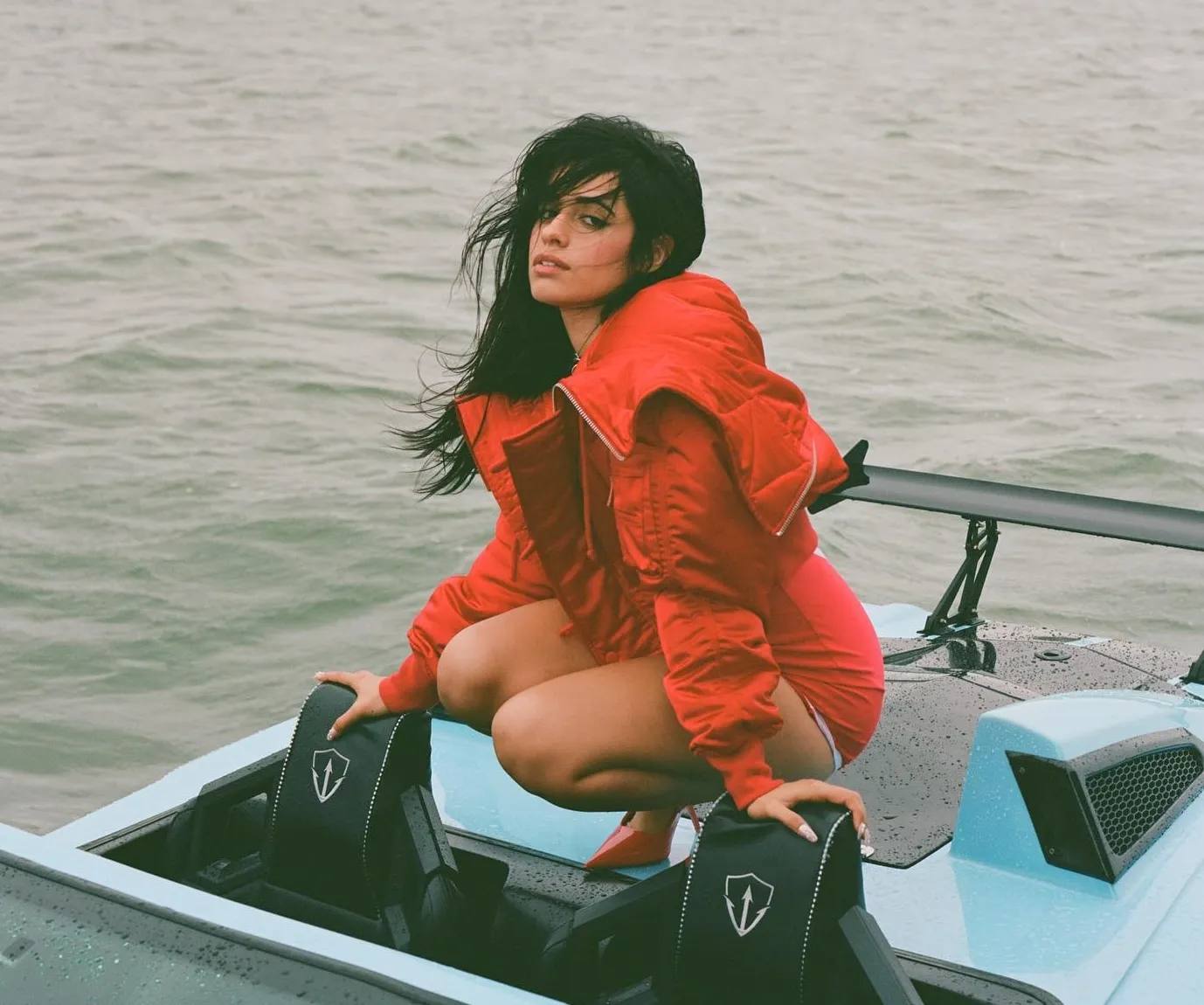 Camila Cabello drived JetCar in Miami, dressed in a short red dress, red puffer and a pair of red heels.