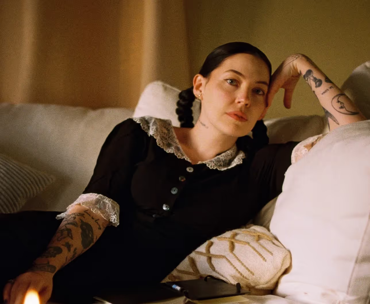 Bishop Biggs wearing black dress on a sofa