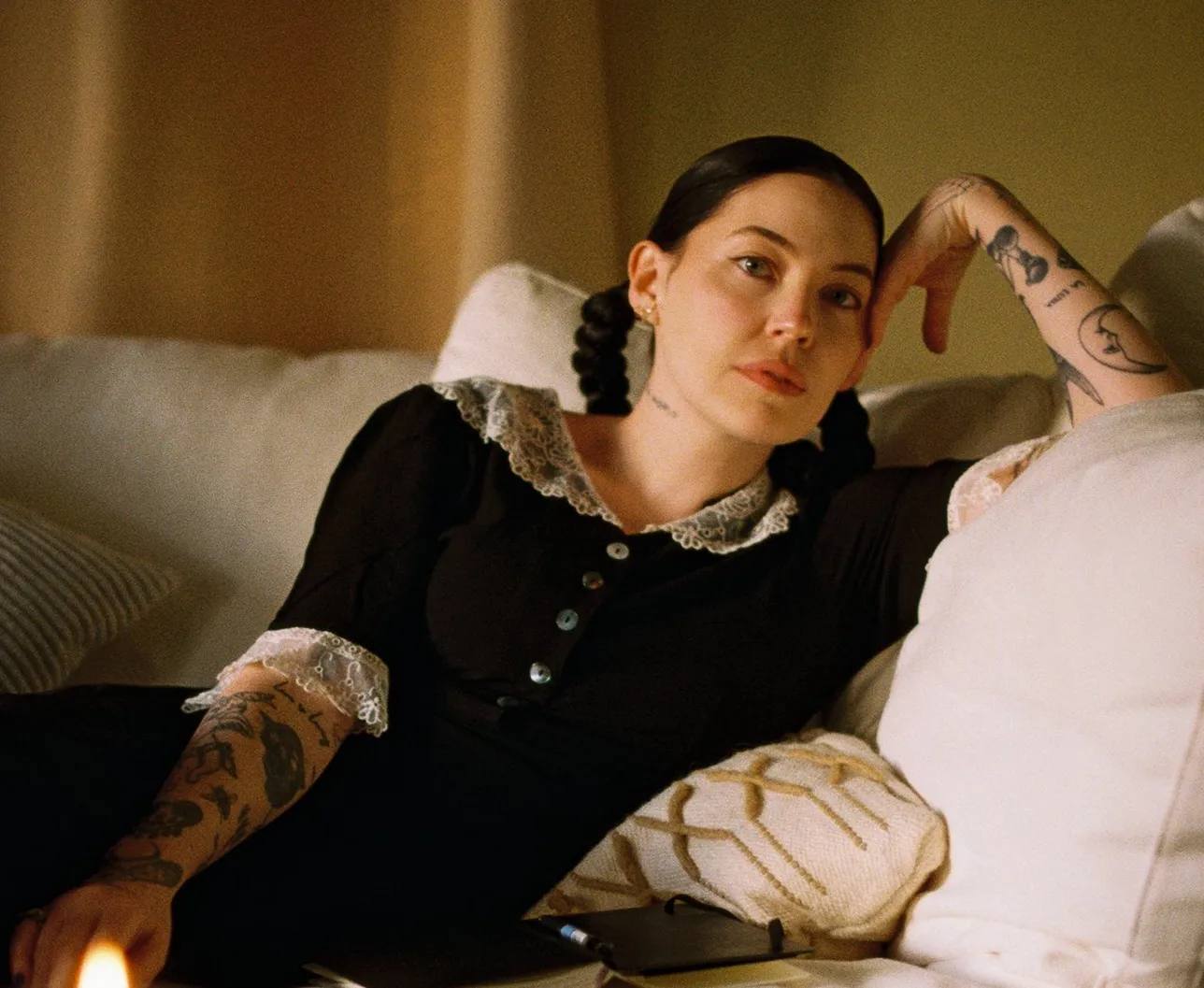 Bishop Biggs wearing black dress on a sofa