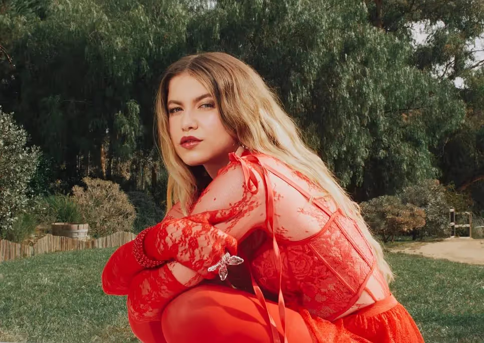 Sofia Reyes wearing lacy red outfit