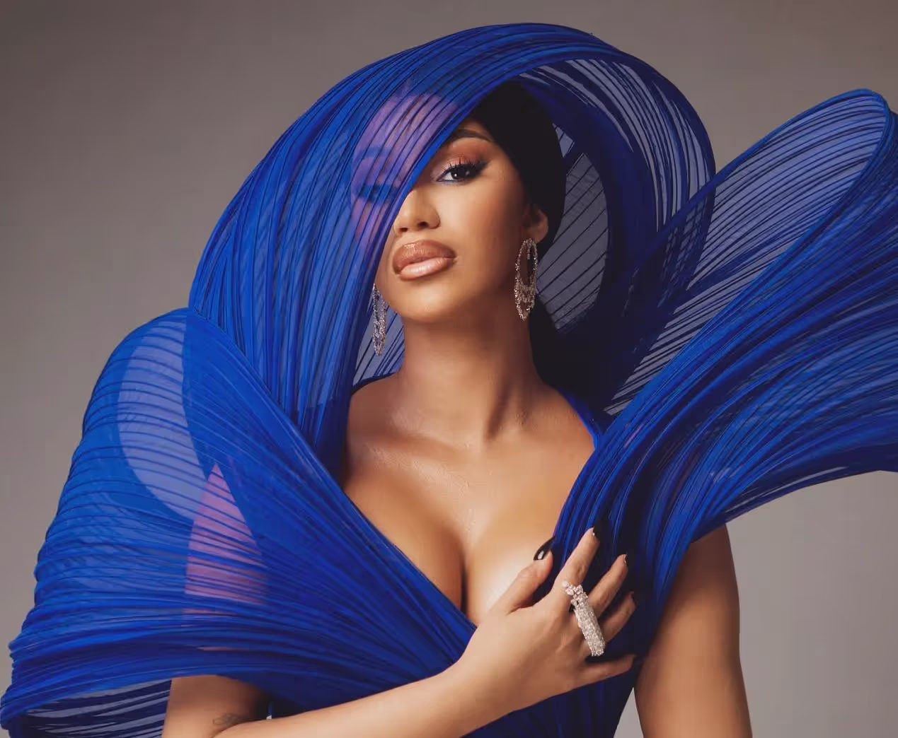 Cardi B wearing blue dress and vail, artist profile, bio