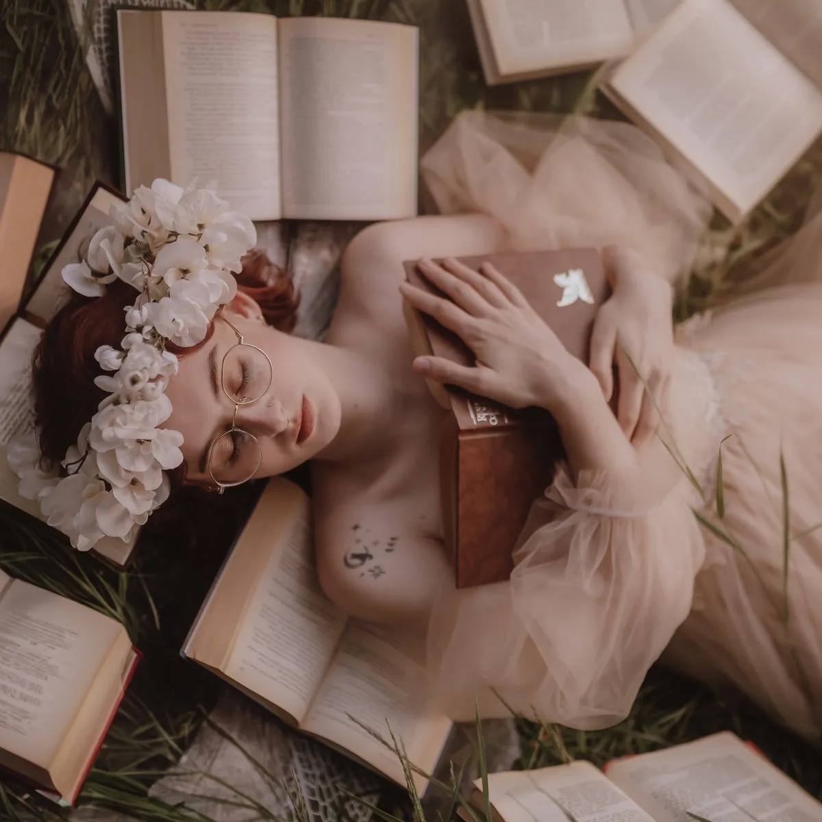 PEGGY wearing romantic dress and flower tiara, surrounded by books, cat tattoo, on a cover of 'Dear Reader' EP