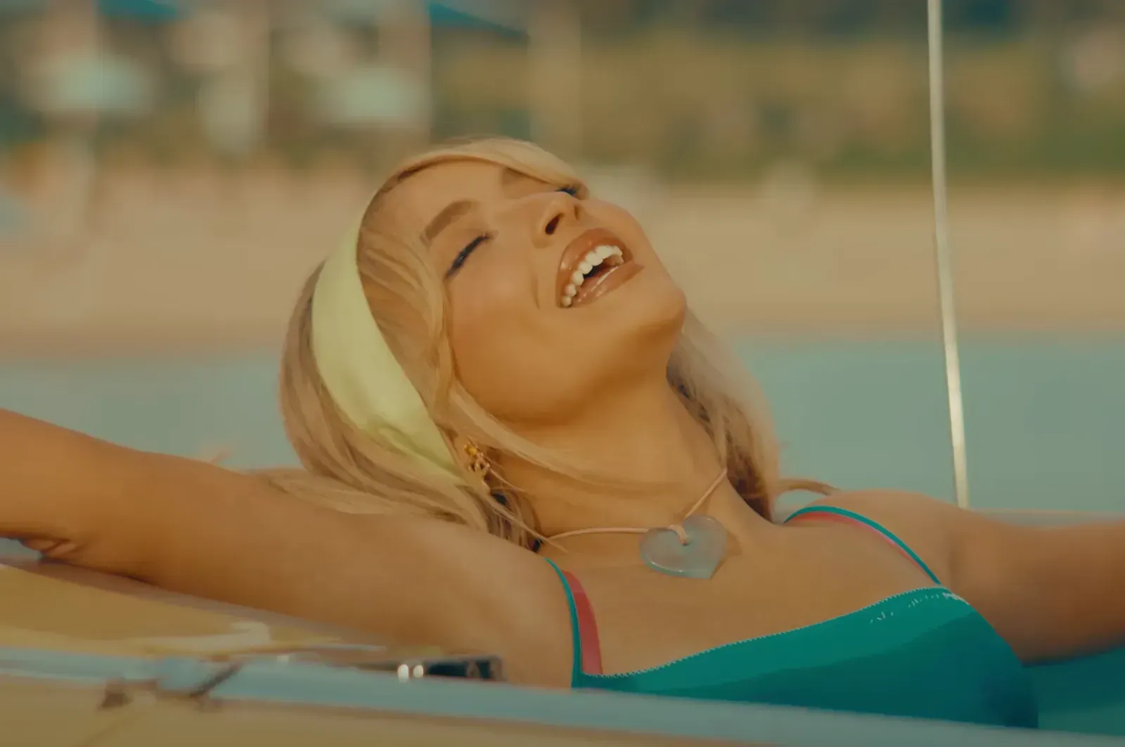 Sabrina Carpenter wearing mini blue dress in "espresso" music video