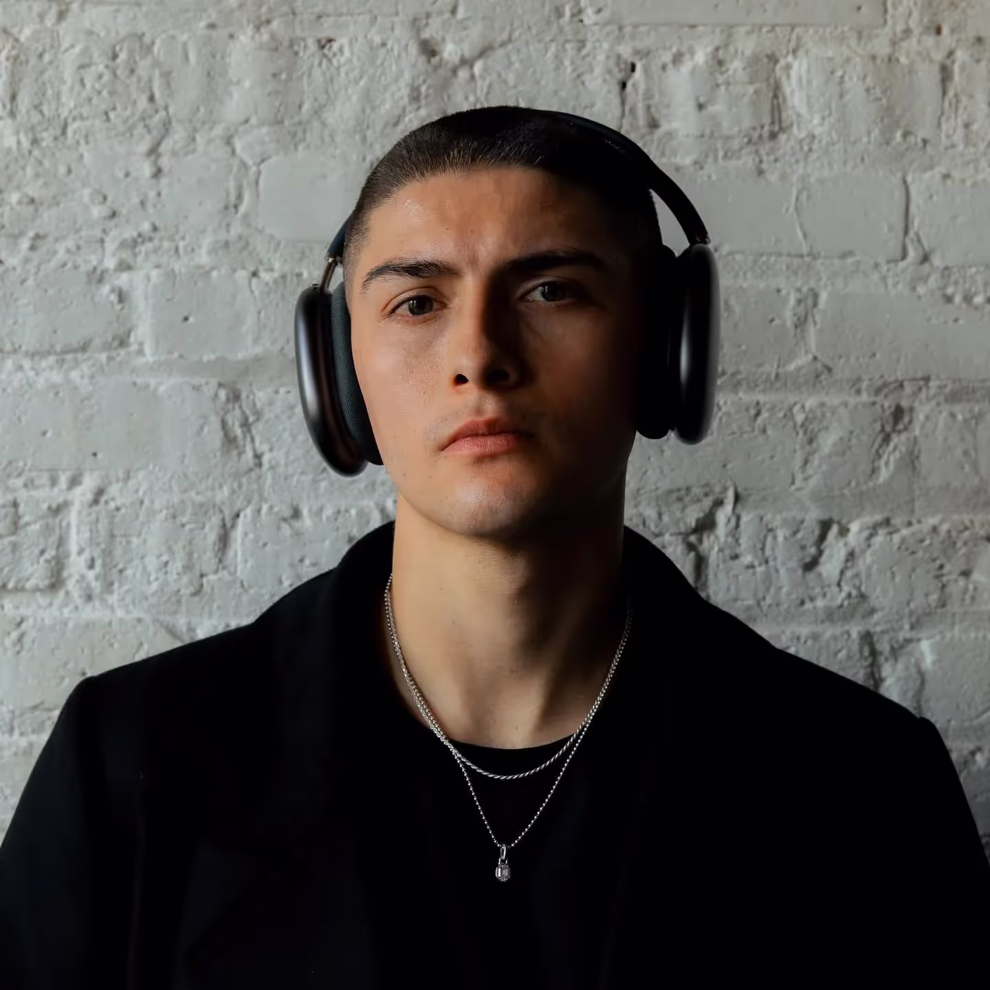 Alex Ponce wearing headphones, artist bio, profile
