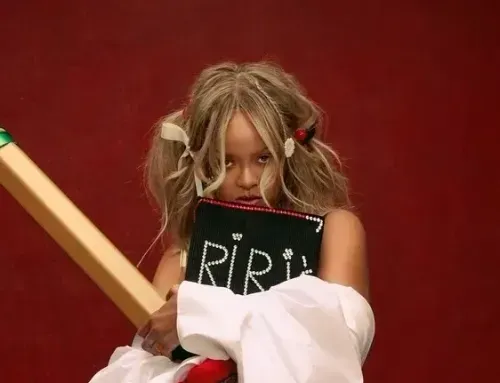 Portrait of Rihanna hiding behind 'Riri's Book' in PumaxFenty campaign in support of new Creeper Phatty Shoes collaboration
