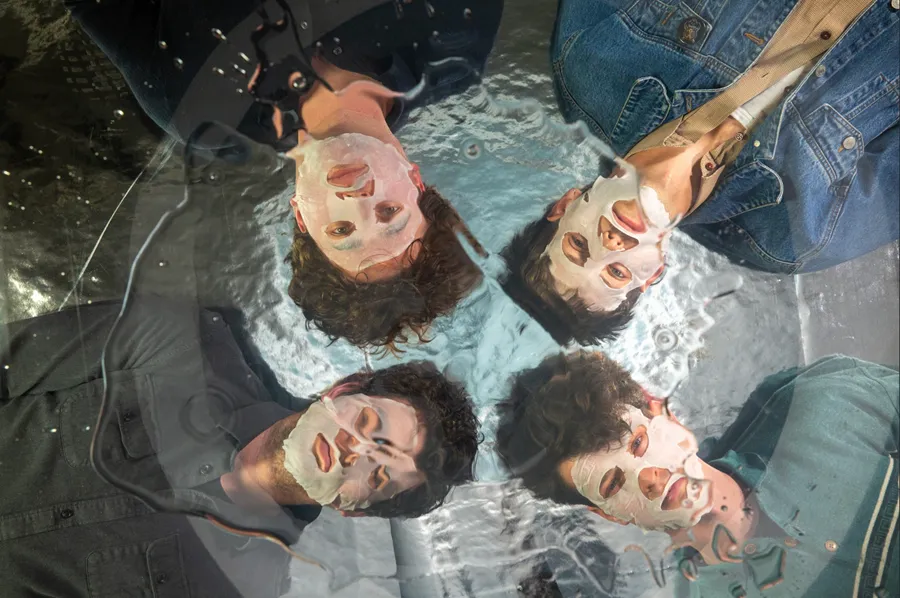 Crackups, all four group members wearing face masks