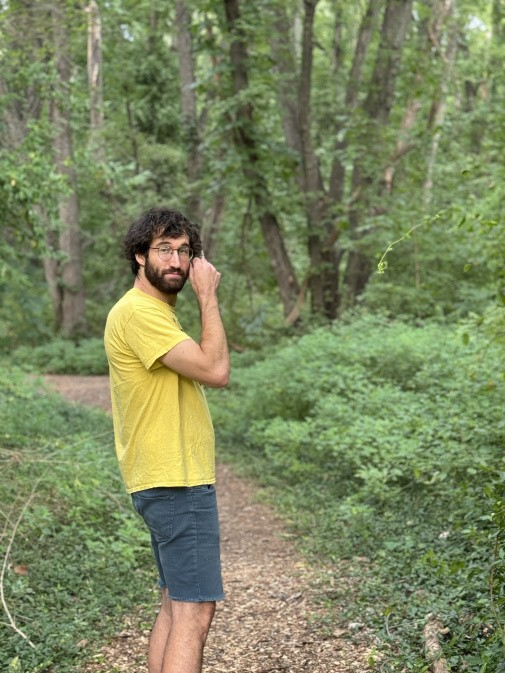 Joe Mygen, hiking in forest, jeans shorts, bright yellow t-shirt, Photo: Corinne Cooke