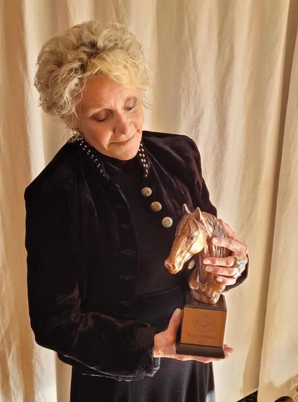 Lucy J. Dalton with Mustang Heritage Hall of Fame statuette, Nashville, TN
