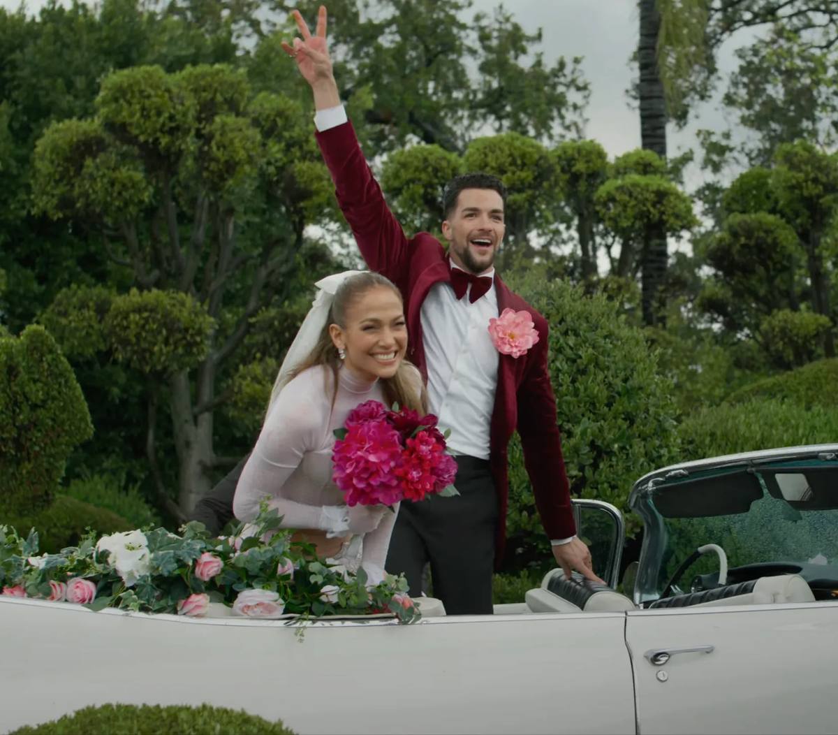 Jennifer Lopez looks stunning in a wedding dress with peony bouquet in a music video 'Can't Get Enough'