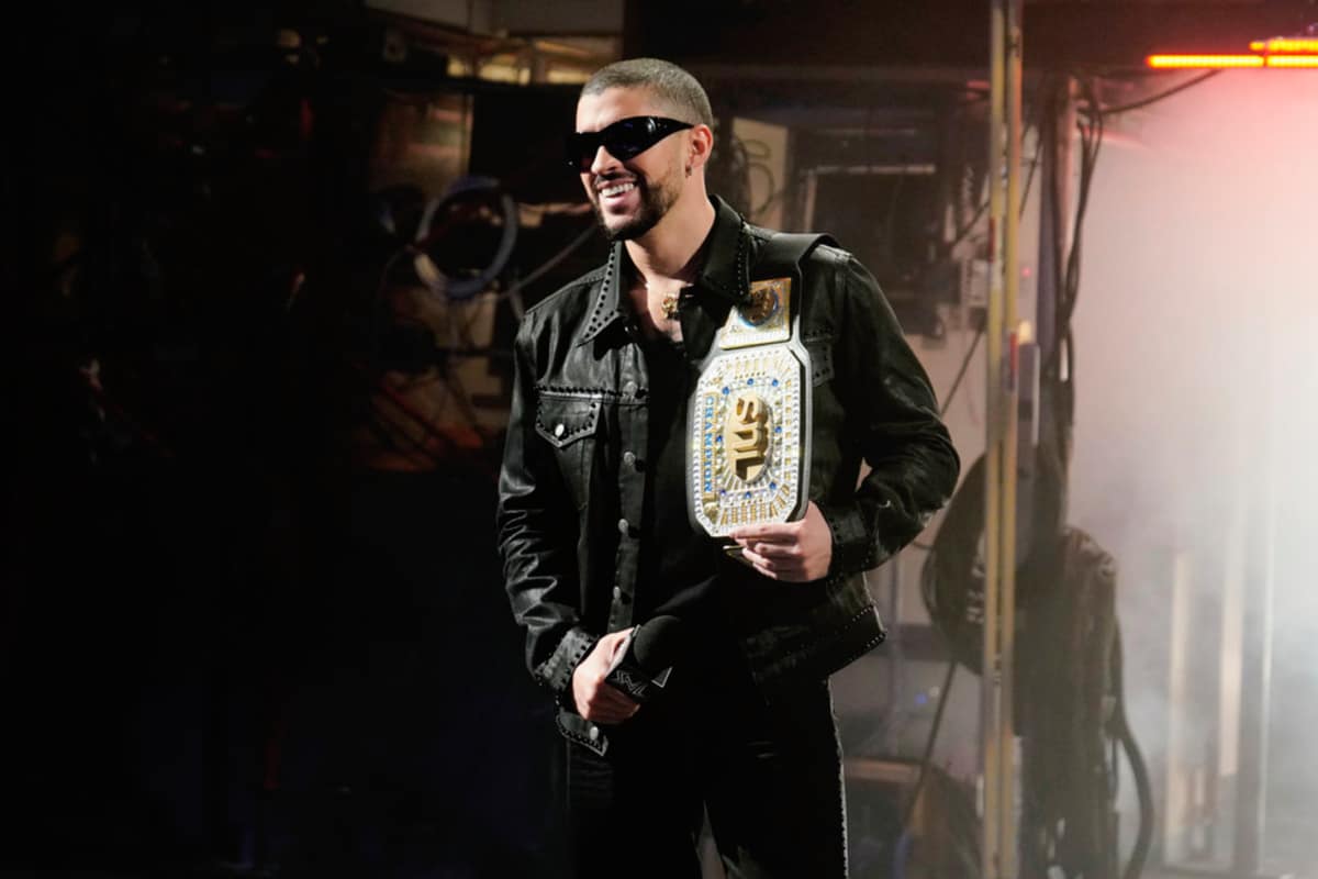 Bad Bunny is wearing leather jacket and the blinked out WWE belt for SNL show