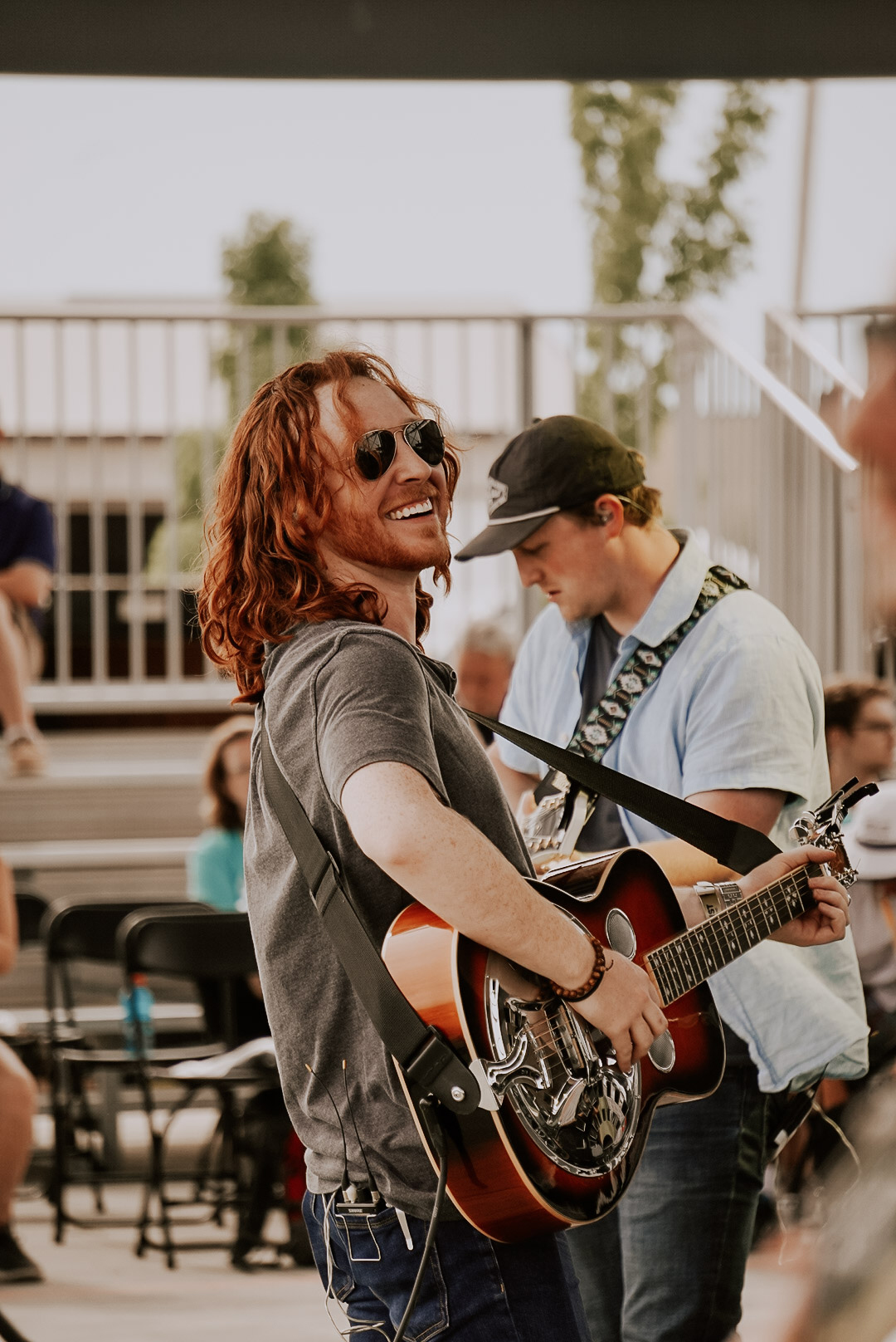 Grayson Russel plays guitar, 'beneath the bow'