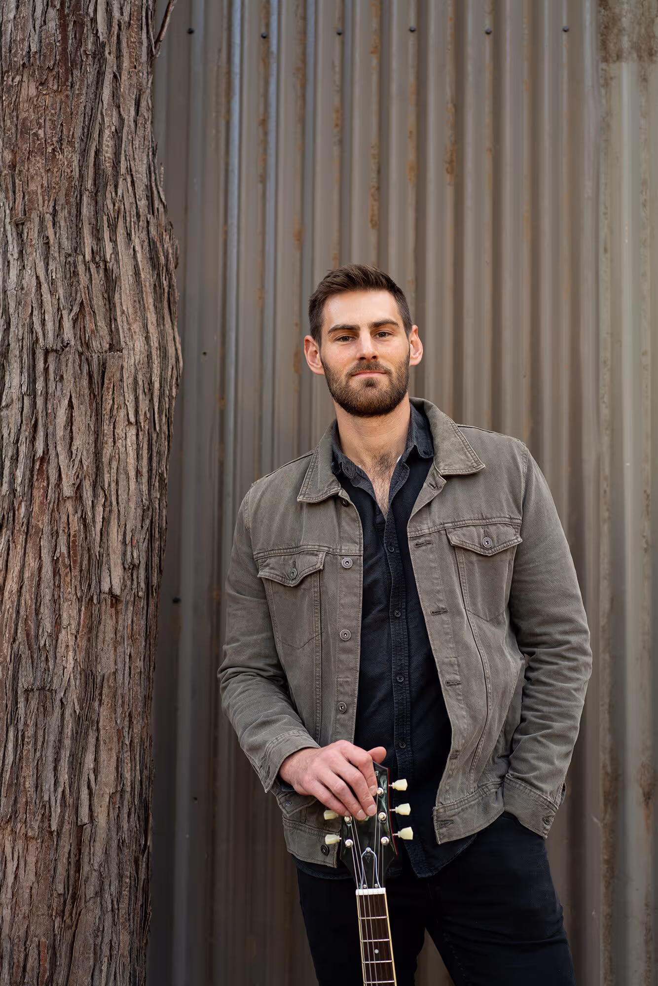 Brandon Poletti, portrait with guitar