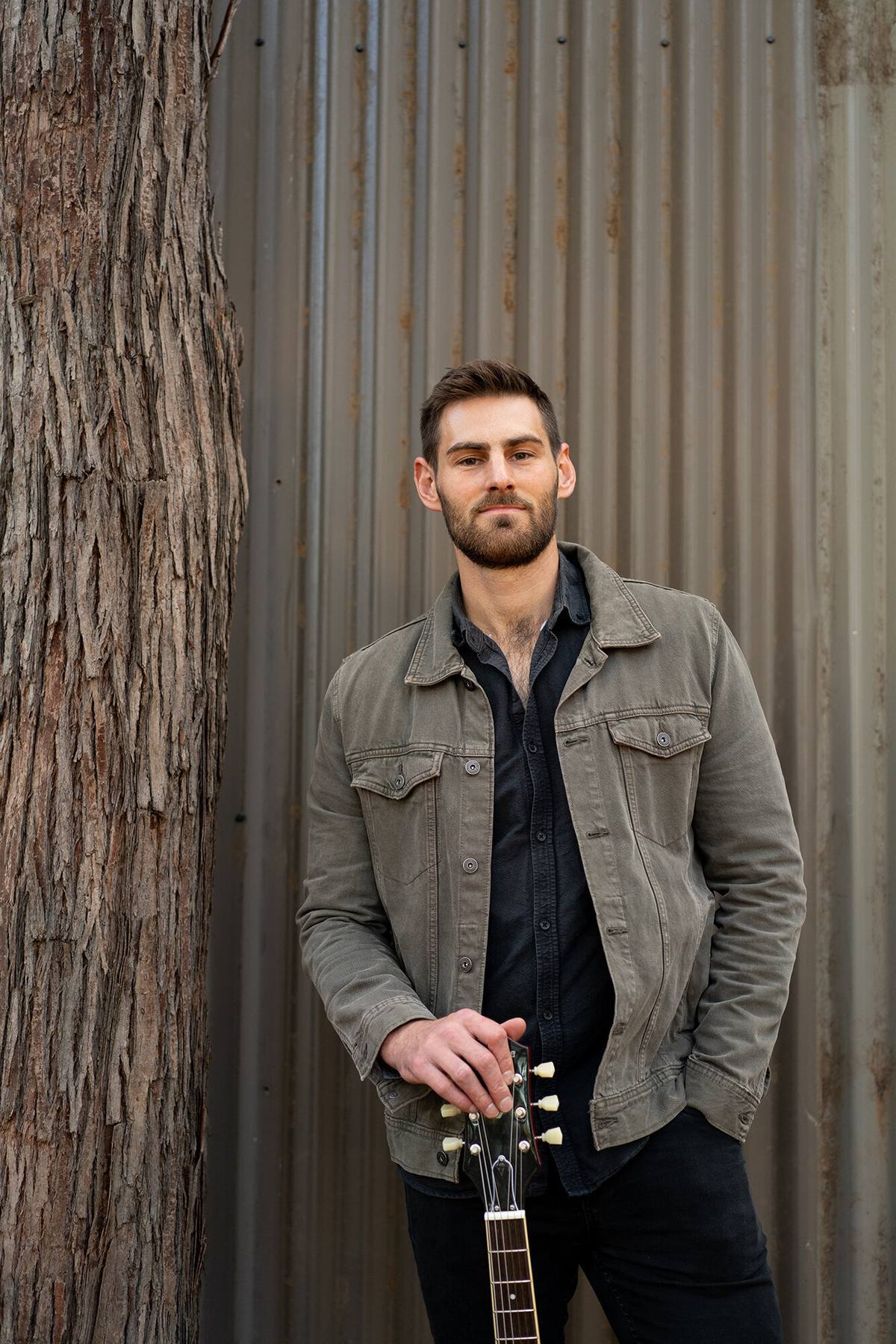 Brandon Poletti, portrait with guitar