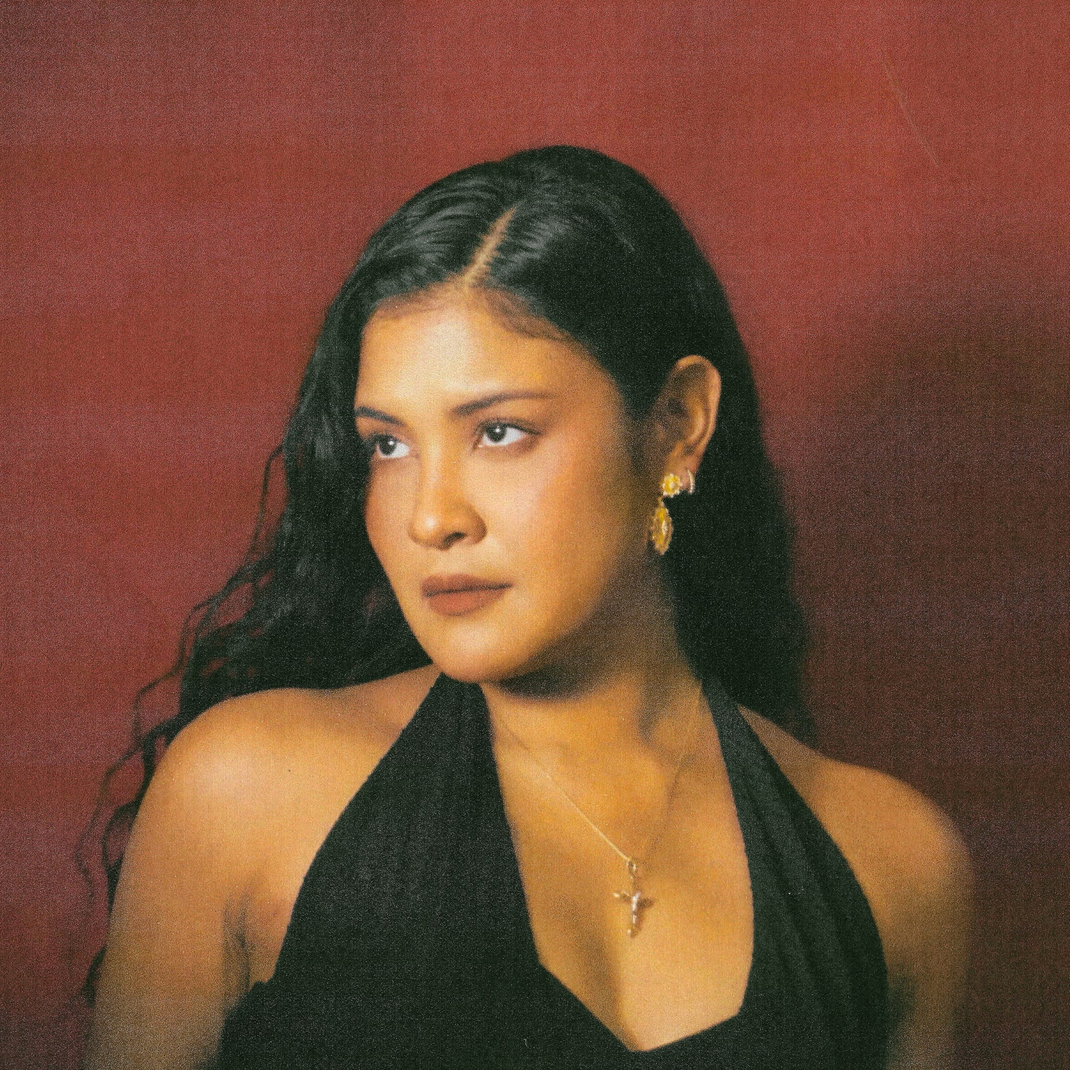 Portrait of Kiana V against a red backdrop.